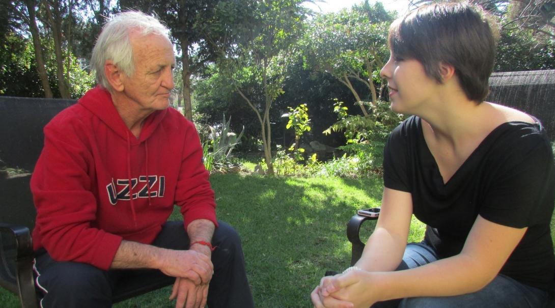 A Journalism intern interviews a local man for a story in Cape Town, South Africa. A local man is interviewed by a student doing a Journalism internship in South Africa.